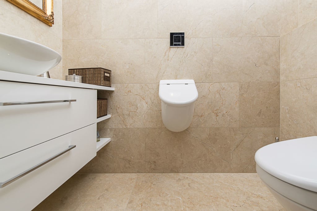 Luxury bathroom with beige Levante Crema patinated floor tiles and wall tiles