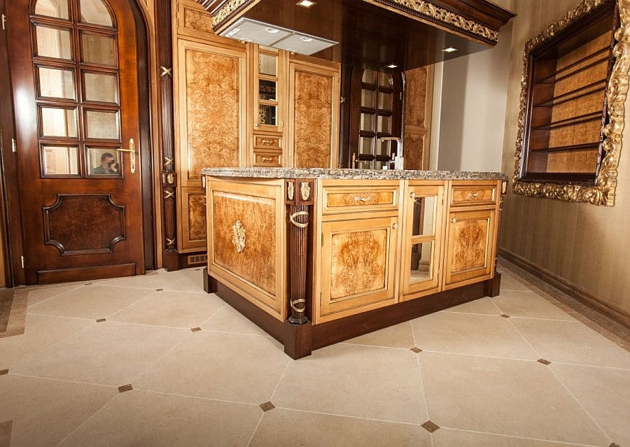 Stone floor with decorative tiles in rustic kitchen