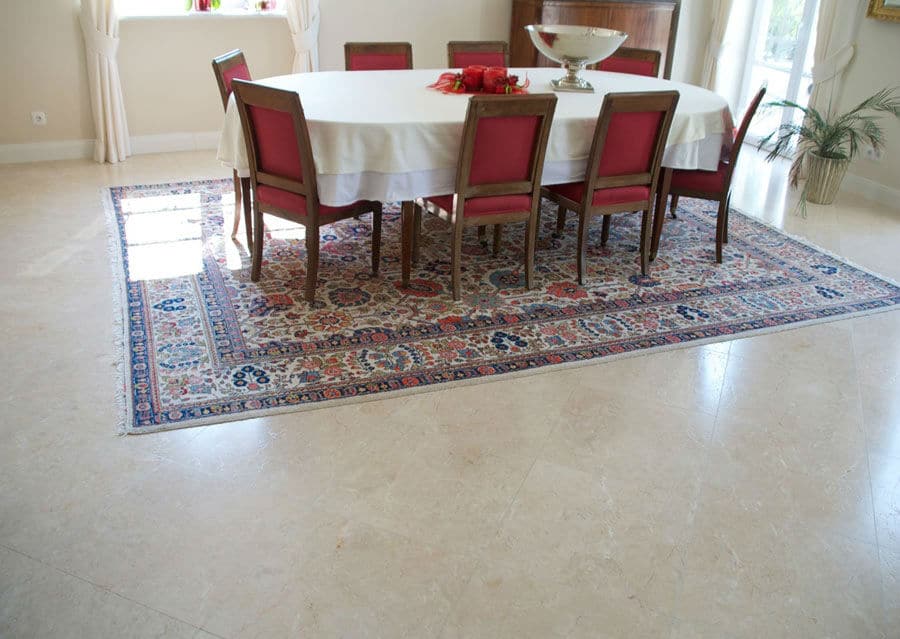Stone floor Levante Crema limestone in cream colour in a dining room with antique carpet