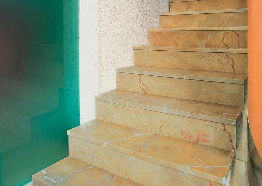Stone staircase with step tiles made of natural stone in orange