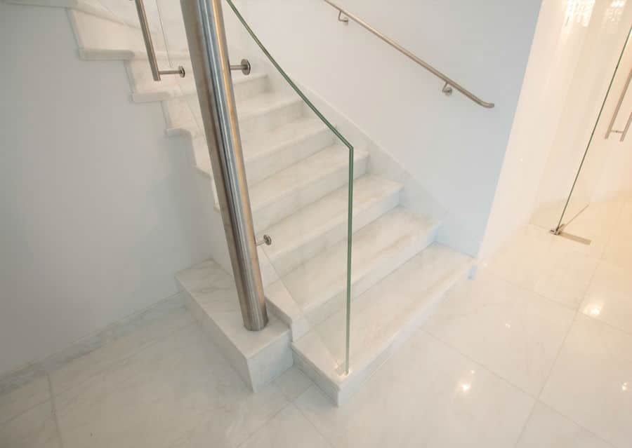 Stone steps in white with glass railing