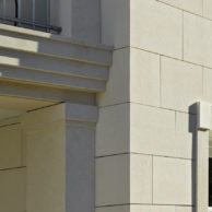 Façade detail with bush-hammered limestone